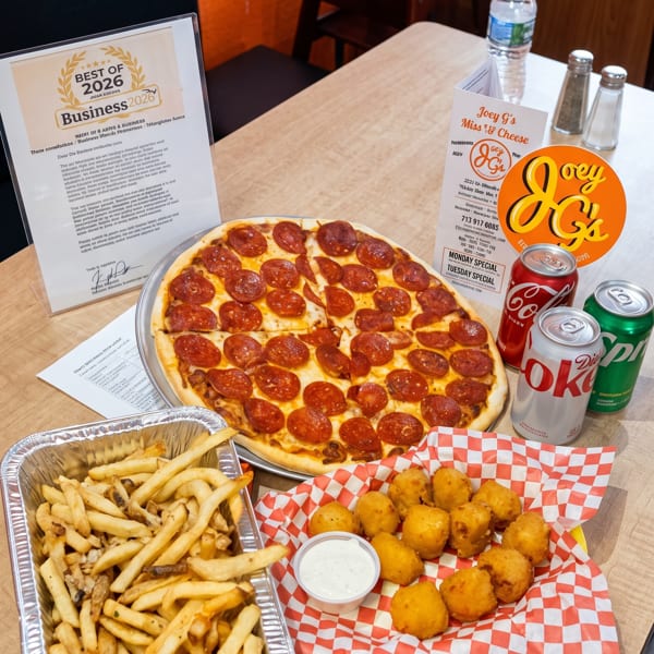A pepperoni pizza, fries, cheese curds, and sodas on a table with a "Best of 2026" award.